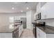 Modern kitchen featuring stainless steel appliances, granite countertops, and a stylish center island at 10257 Sequoia Falls Pl, Las Vegas, NV 89149