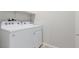 Laundry room features modern washing machine, dryer and storage shelf at 10257 Sequoia Falls Pl, Las Vegas, NV 89149
