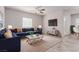 Comfortable living room featuring a stylish blue sectional, ceiling fan, and contemporary decor at 10257 Sequoia Falls Pl, Las Vegas, NV 89149