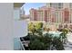 Balcony view overlooking lush landscaping, the pool, and Las Vegas high-rise buildings at 125 E Harmon Ave # 321, Las Vegas, NV 89109
