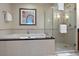 Bright bathroom with a large bathtub and shower, with white tile and chrome fixtures at 125 E Harmon Ave # 321, Las Vegas, NV 89109