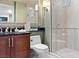 Bathroom featuring a vanity with cabinets, and a walk-in shower with glass doors and tiled walls at 125 E Harmon Ave # 321, Las Vegas, NV 89109