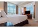 Comfortable bedroom with a large bed, a desk, and a fantastic view of the city at 125 E Harmon Ave # 321, Las Vegas, NV 89109