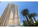 Striking high-rise building with glass exterior and lush palm tree landscaping at 125 E Harmon Ave # 321, Las Vegas, NV 89109