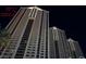 Stunning high-rise condo building with modern architecture and city views at night at 125 E Harmon Ave # 321, Las Vegas, NV 89109