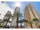 Beautiful exterior view featuring high-rise buildings and mature palm trees at 125 E Harmon Ave # 321, Las Vegas, NV 89109
