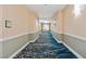 Hallway with decorative carpeting and neutral wall colors leading to the living spaces at 125 E Harmon Ave # 321, Las Vegas, NV 89109