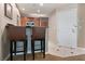 Kitchen area featuring a breakfast bar with seating, ample cabinet space and access to the front door at 125 E Harmon Ave # 321, Las Vegas, NV 89109