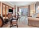 Comfortable living room boasts plush seating, modern decor, and city views from the large sliding glass doors at 125 E Harmon Ave # 321, Las Vegas, NV 89109