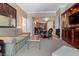 Condo living area with a comfortable sofa, glass coffee table, dining area, and built-in entertainment center at 125 E Harmon Ave # 321, Las Vegas, NV 89109