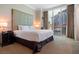 Spacious main bedroom with a plush bed, modern furnishings, and expansive windows offering city views at 125 E Harmon Ave # 321, Las Vegas, NV 89109