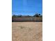 Expansive backyard with gravel ground and a high block wall and metal gate, providing a secure outdoor space at 131 Copper St, Henderson, NV 89015
