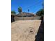 Large backyard featuring a gravel surface and brick wall, perfect for outdoor activities and landscaping opportunities at 131 Copper St, Henderson, NV 89015