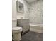 Bathroom with marble tiled walls and gray vanity at 131 Copper St, Henderson, NV 89015
