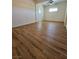 Bright bedroom features wood-look floors, a ceiling fan, and a view into another room at 131 Copper St, Henderson, NV 89015