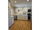 Modern kitchen featuring white cabinets, stainless steel appliances, and a granite countertop at 131 Copper St, Henderson, NV 89015