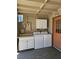 Outdoor laundry area with new appliances, storage, and an entrance door at 131 Copper St, Henderson, NV 89015