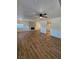Inviting living area with wood floors, ceiling fan, and access to the kitchen at 131 Copper St, Henderson, NV 89015