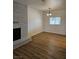 Living area with brick fireplace, wood flooring, and window with outside view at 131 Copper St, Henderson, NV 89015