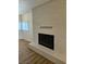 Living room featuring fireplace, natural lighting, and new wood flooring at 131 Copper St, Henderson, NV 89015