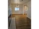 Living room featuring wood flooring, open to the kitchen with ample space at 131 Copper St, Henderson, NV 89015