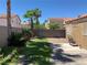 Lush backyard with lawn, desert landscaping, block wall and patio at 1712 Matador Way, Las Vegas, NV 89128