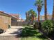 Lush green back yard, block wall, patio and mature palm trees at 1712 Matador Way, Las Vegas, NV 89128