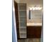 Bathroom features a marble sink with vanity and mirrored medicine cabinet and a tall storage cabinet at 1712 Matador Way, Las Vegas, NV 89128