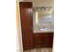 Bathroom features a cabinet with shelves, vanity, sink, mirror and modern light fixture at 1712 Matador Way, Las Vegas, NV 89128