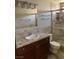 Bathroom features a sink with granite counters, wood cabinets, and tile shower with glass door at 1712 Matador Way, Las Vegas, NV 89128