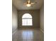 Bedroom featuring tiled floors, ceiling fan with lights and large window at 1712 Matador Way, Las Vegas, NV 89128