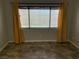 Bright bedroom featuring a window with yellow curtains and neutral walls and tile flooring at 1712 Matador Way, Las Vegas, NV 89128