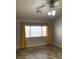 Bedroom featuring window, ceiling fan with lights, and yellow drapes at 1712 Matador Way, Las Vegas, NV 89128