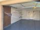 View of organized garage space featuring painted floor and wall shelving for storage at 1712 Matador Way, Las Vegas, NV 89128