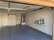 View of garage space featuring painted floor, water heater, shelving and door to house at 1712 Matador Way, Las Vegas, NV 89128