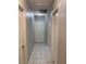 Hallway with tiled floors, several doors, and access to storage at 1712 Matador Way, Las Vegas, NV 89128