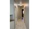 Hallway with tiled floors, several doors, and access to rooms at 1712 Matador Way, Las Vegas, NV 89128