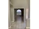 Bright hallway with tile flooring leading to a room with an arched window at 1712 Matador Way, Las Vegas, NV 89128