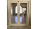 Bright living room with tile floors, double doors, and a view of the dining area at 1712 Matador Way, Las Vegas, NV 89128