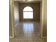 Empty Living Room with tiled flooring and a large window with a arched top at 1712 Matador Way, Las Vegas, NV 89128