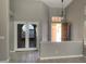 Open living room with natural light, tile flooring and glass panel doors at 1712 Matador Way, Las Vegas, NV 89128