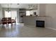 Open floor plan with a dining area, fireplace, tile flooring, stainless steel appliances, and backyard view at 1712 Matador Way, Las Vegas, NV 89128