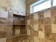 Shower featuring built-in tile shelving and small window for natural light at 1712 Matador Way, Las Vegas, NV 89128