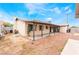 Exterior view of backyard with patio, minimal landscaping, and desert surroundings under a sunny sky at 1733 N Michael Way, Las Vegas, NV 89108