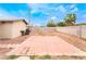 Spacious backyard featuring block wall, desert landscaping, and concrete patio with potential for customization at 1733 N Michael Way, Las Vegas, NV 89108