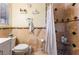 Elegant bathroom featuring travertine tile, mosaic accents, shower with a built-in seat and modern fixtures at 1733 N Michael Way, Las Vegas, NV 89108
