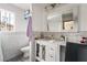 Bright, updated bathroom featuring a vanity, sink, and decorative mirror with modern fixtures at 1733 N Michael Way, Las Vegas, NV 89108