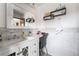 Bright bathroom featuring marble countertop, large mirror, and decorative shelves filled with bathroom essentials at 1733 N Michael Way, Las Vegas, NV 89108