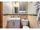 Charming bathroom with white vanity, modern fixtures, tiled walls and a well-lit mirror at 1733 N Michael Way, Las Vegas, NV 89108