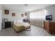 Bedroom featuring neutral decor, laminate floors, a comfortable bed, and a wall-mounted TV at 1733 N Michael Way, Las Vegas, NV 89108
